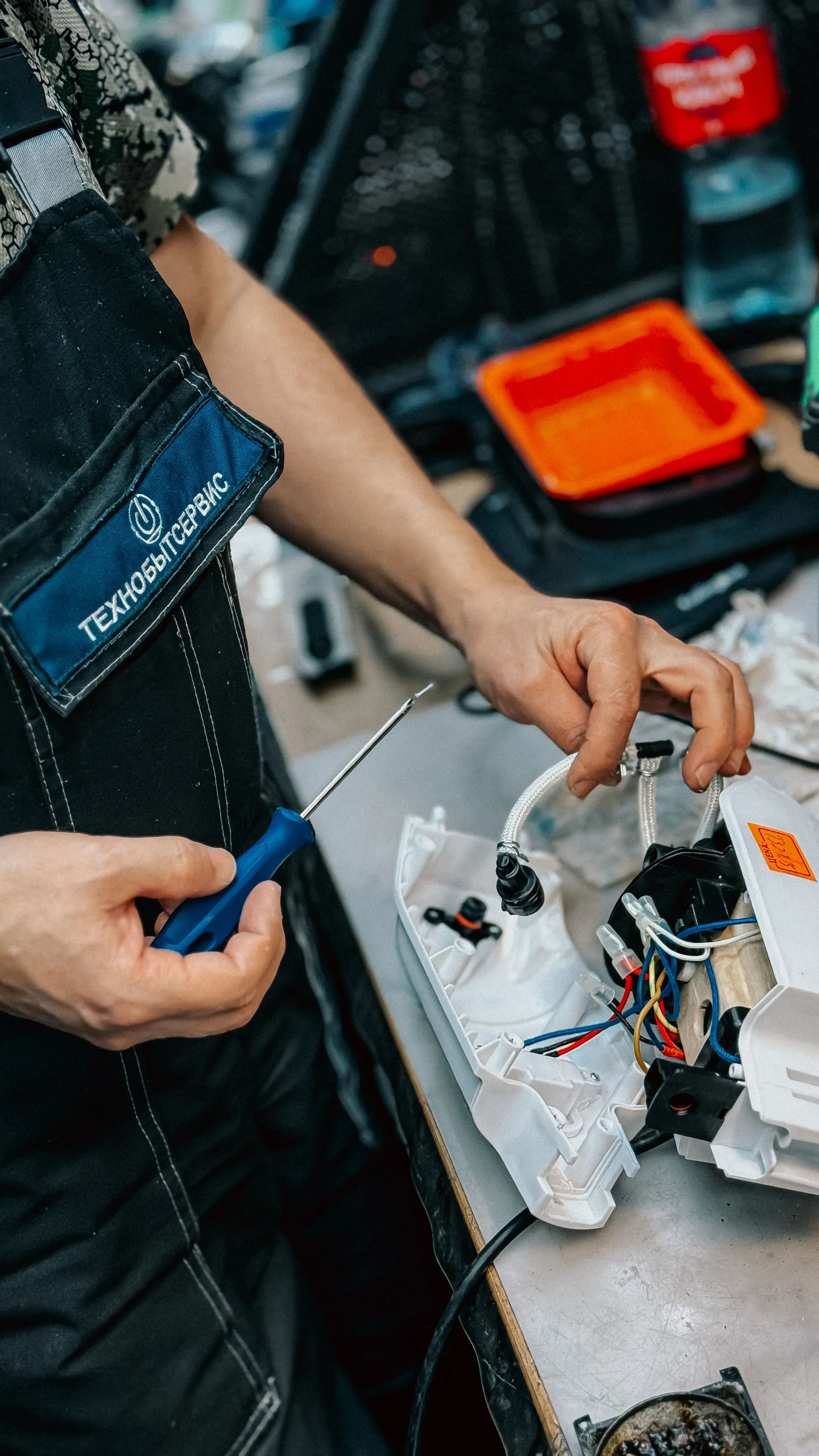Technicien examinant les connexions d’un équipement électrique ouvert.